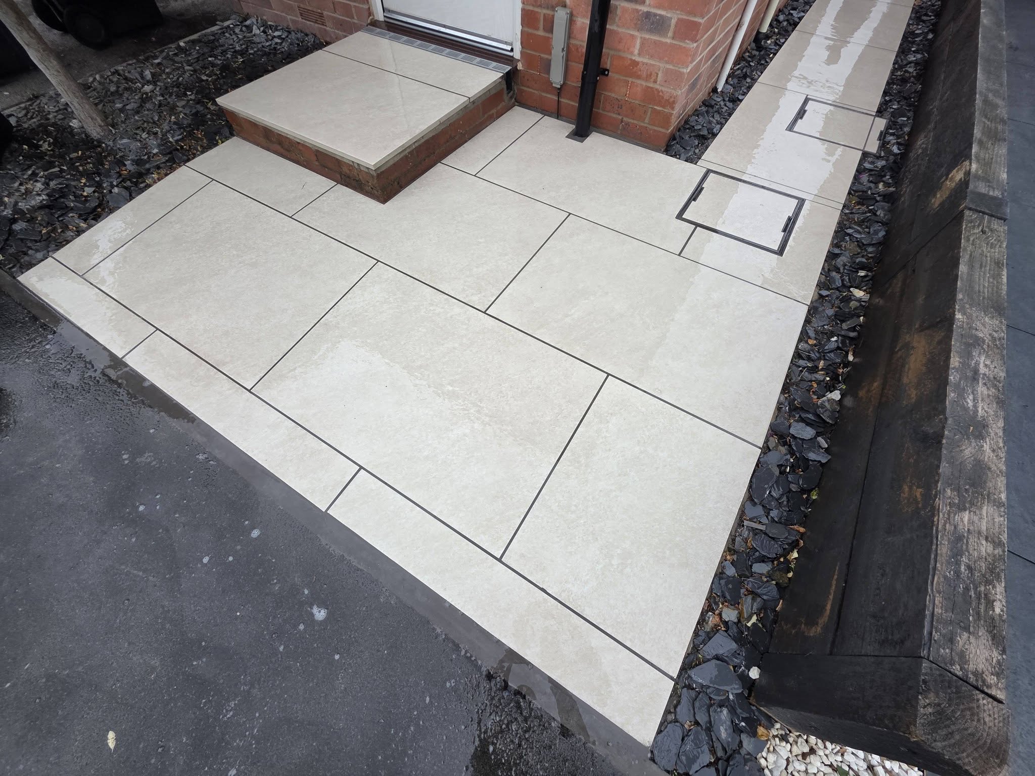 Pale path and step leading to a back door, with a slate border
